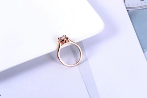Macro detail of rose gold engagement ring with square-cut cubic zirconia and pave setting