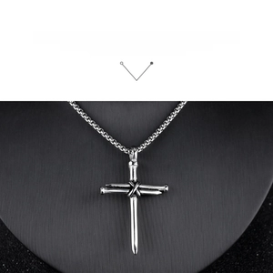 Detail of silver stainless steel nail cross pendant on box chain necklace