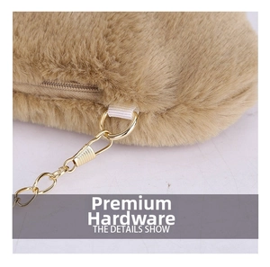 Detail of premium golden hardware and metal chain link on a plush tan faux fur handbag