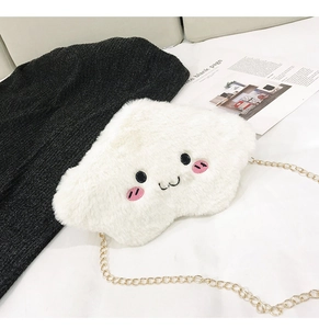 Close-up of white plush cloud bag with cute smiling face embroidery and gold chain strap