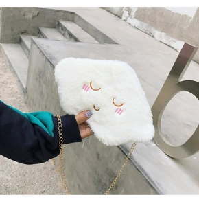 Close-up of a white plush cloud bag with cute embroidery and a gold chain strap
