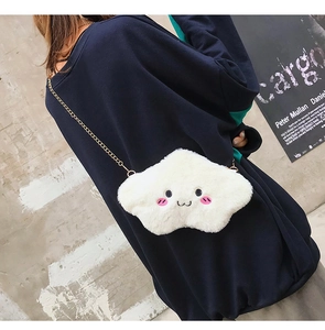 Close-up of white plush cloud bag featuring cute embroidered smiley face and gold chain