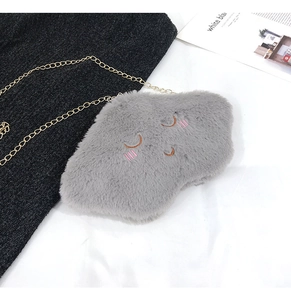 Detail of grey plush cloud bag with smile embroidery and a golden chain strap