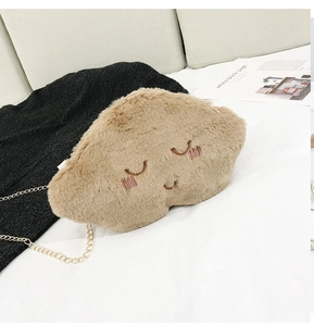 Detail of light brown plush cloud bag with cute embroidery and gold metal chain