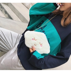 Close-up of white plush cloud-shaped crossbody bag with pink embroidery and chain