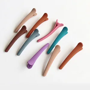 Set of 8 colorful matte hair clips in Morandi tones on a minimalist white background