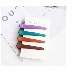 Set of four matte colorful hair clips in purple, teal, orange, and coffee on a card