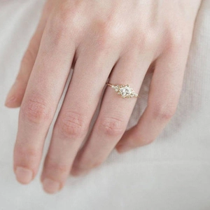 Elegance women's gold plated ring with square zircon stone shown on hand in detail