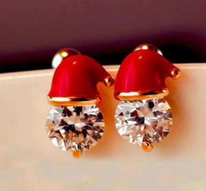 Macro detail of Christmas snowman hat stud earrings with red enamel and clear zircon