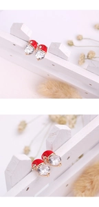 Close-up of Christmas snowman earring featuring red enamel hat and sparkling cubic zirconia