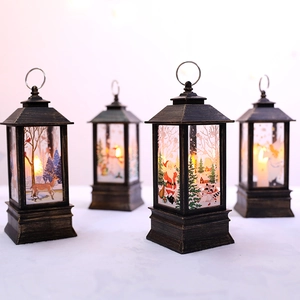 Set of four Christmas lanterns with warm LED candles and bronze festive patterns
