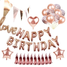 Rose gold jungle themed birthday party set with foil balloons and leaf decorations