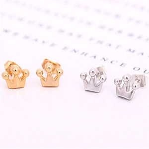 Macro detail of crown stud earrings in gold and silver finish with secure butterfly back