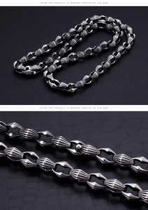 Macro detail of chunky stainless steel curb chain with ribbed oval links and vintage finish