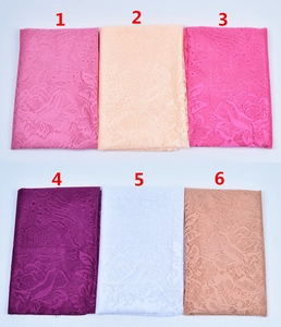 Close-up of floral lace fabric samples in six elegant colors with rose patterns