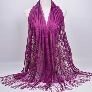Elegant purple lace shawl scarf with hollow flower pattern and tassel fringe on mannequin