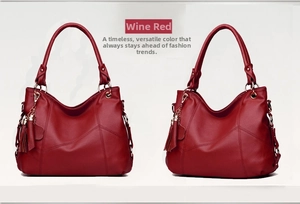 Detail view of wine red tote bag featuring V-shaped stitching and tassel accent