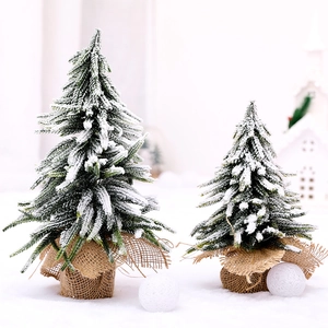 Mini snowy Christmas trees with burlap bases for winter holiday tabletop decoration