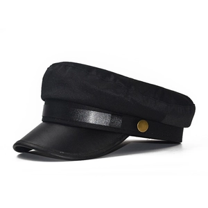 Detail view of cotton baker boy hat with faux leather visor and gold button accents