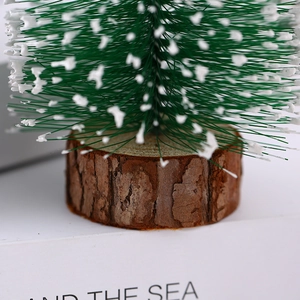 Mini Christmas tree with white snow tips and natural wood base for desktop decor