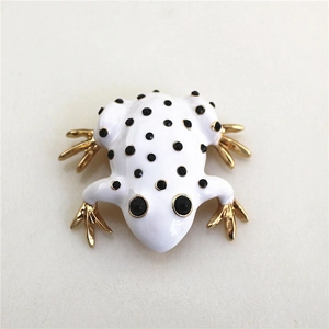 Elegant frog brooch with white enamel, black spots, and pearls in gold finish