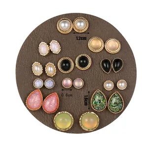 Cat eye resin and pearl earring set showing varied sizes and vintage emerald teardrop styles