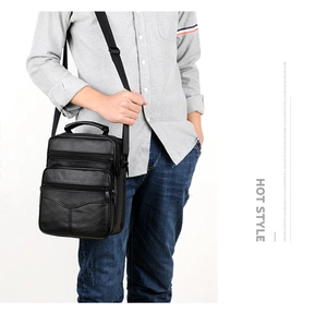 Men's genuine leather business briefcase with multiple zippers shown on a model