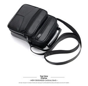 Macro view of black pebbled leather texture and reinforced stitching on mens briefcase