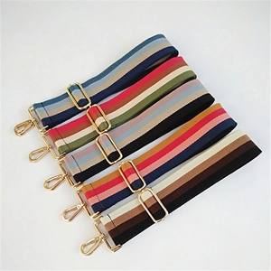 Close-up of five colorful striped cotton bag straps with adjustable gold metal buckles