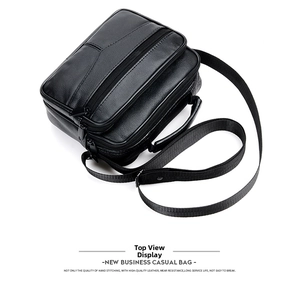 Top view of a black genuine leather business briefcase with multiple zippers and top handle