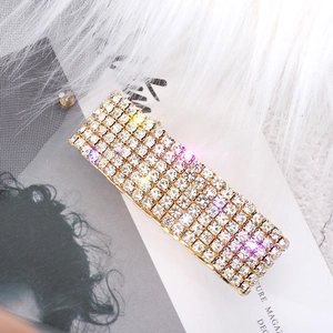 Close-up of sparkling 8-row rectangular rhinestone hair clip with a golden metal base