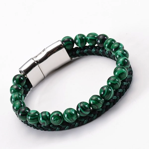 Macro detail of natural malachite beads and braided leather cord with magnetic metal clasp