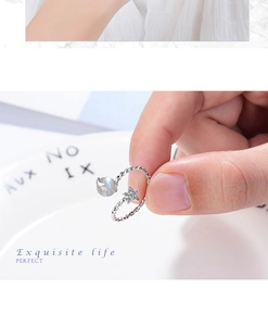 Detailed close-up of adjustable star and moon open ring with moonlight stone on finger