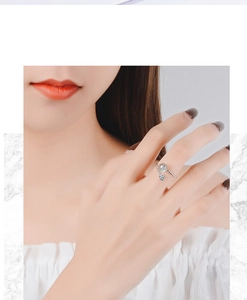 Close-up of adjustable silver ring with star gemstone and pearl worn by a model