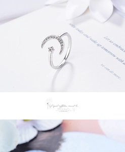 Macro shot of silver moon and star open ring with sparkling cubic zirconia inlay