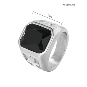 Detail of 18mm square black gemstone ring with engraved cross on silver steel side