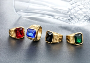 Macro view of vintage gold rings with colorful square gemstones and cross engraving