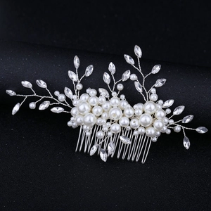 Detailed view of handmade bridal hair comb with silver wire, white pearls and sparkling rhinestones