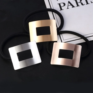 Three hollow rectangular metal hair ties in gold, silver, and rose gold finishes