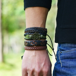 Detail of multi-layer woven leather bracelets with bronze star charm on wrist