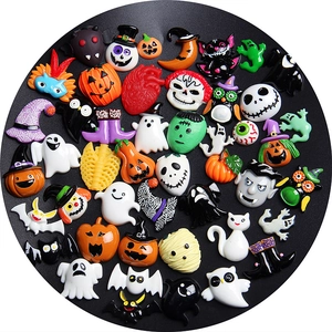 Variety of Halloween resin charms featuring pumpkins, ghosts, and bats on black background