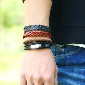 Close-up of a 12-piece multi-layer woven leather bracelet set on a male model's wrist