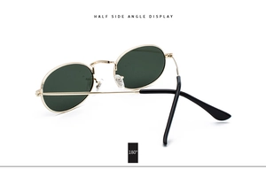 Side view of vintage oval metal sunglasses with gold frame and dark green lenses