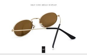 Side angle display of vintage oval sunglasses with gold metal frame and brown lenses