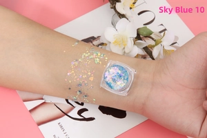 Detail of Sky Blue 10 cosmetic glitter gel with star and heart shapes on skin arm swatch