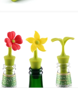 Close-up of floral silicone wine stoppers in red, yellow and green sprout designs