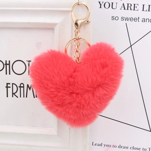 Detailed close-up of a plush pink heart-shaped keychain with gold lobster clasp