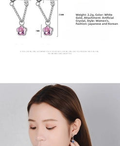 Detail view of pink crystal star drop earrings with dimensions of 25mm length and 7mm width