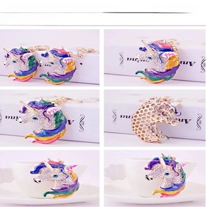 Detail of a gold alloy unicorn keychain with colorful rhinestones and enamel finish