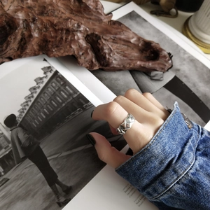 Detail of a 925 sterling silver geometric ring on finger with vintage lifestyle denim styling